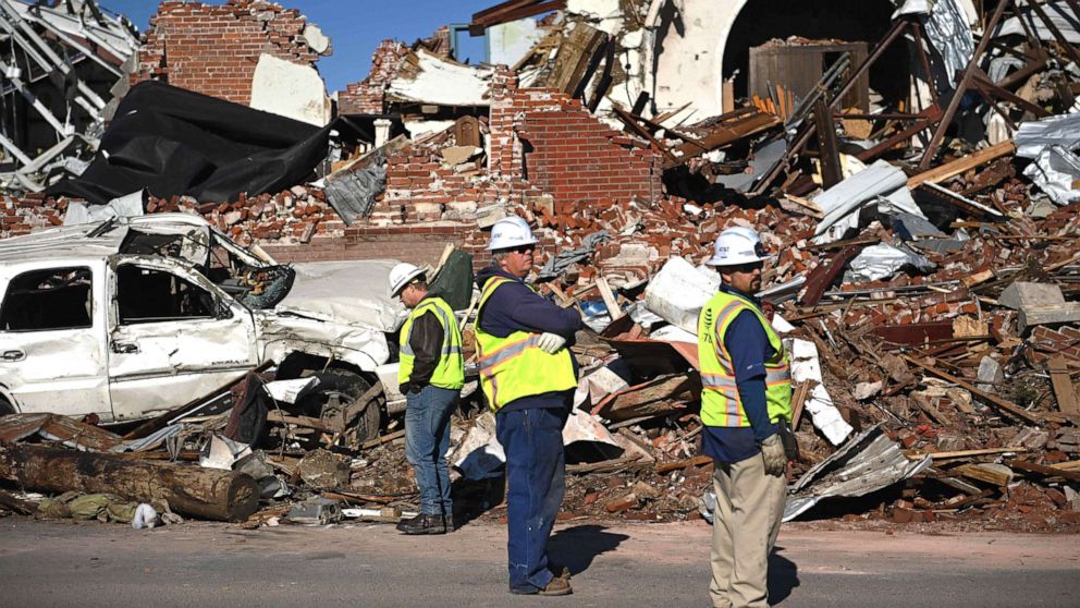 PHOTO: Workers survey tornado damage after extreme weather hit the region Dec. 12, 2021, in Mayfield, Ky.