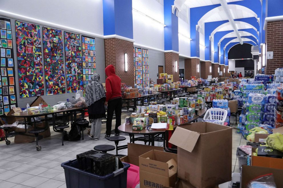 PHOTO: Donations are kept in the hallway of South Warren High School the night after tornadoes hit the community, at Bowling Green, Ky., Dec. 11, 2021.