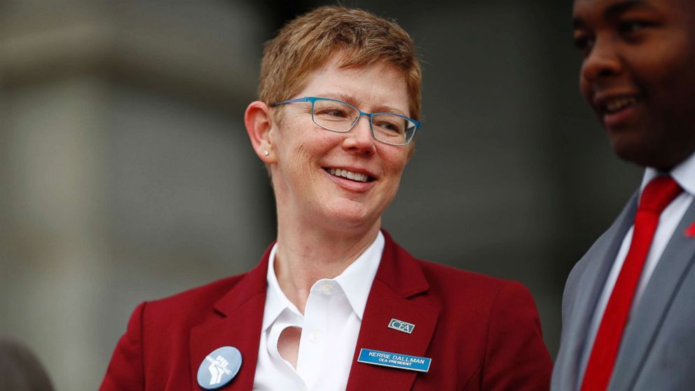 PHOTO: Kerrie Dallman, president of the Colorado Education Association, jokes with speakers during a rally outside the State Capitol, April 16, 2018, in Denver.