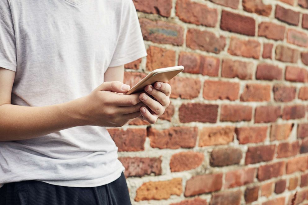 PHOTO: A person uses a cell phone.