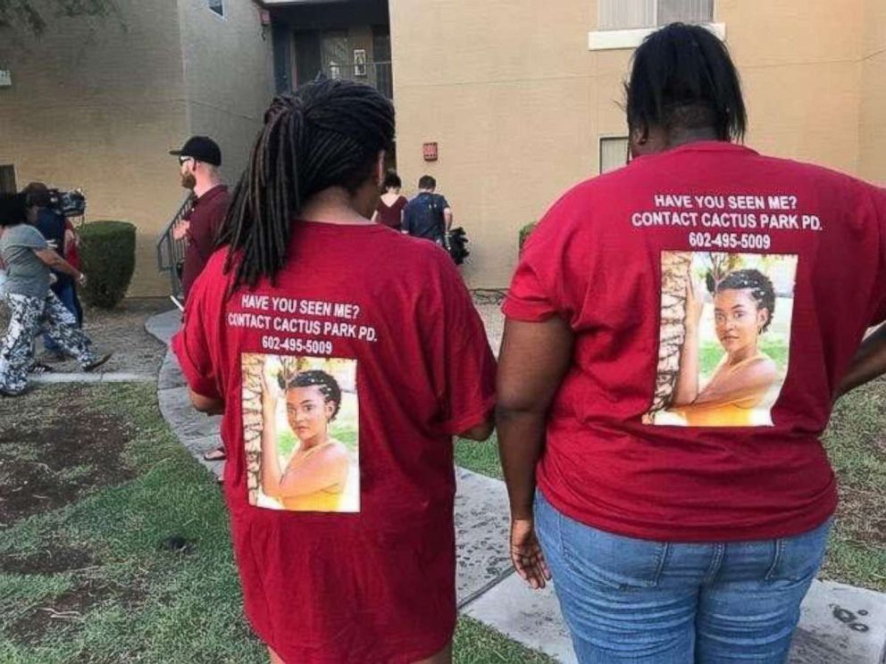 Friends of Kiera Bergman pose with photos of the missing girl on the back of their T-shirts at a vigil for the teen from Phoenix on Saturday, Aug. 11, 2018.