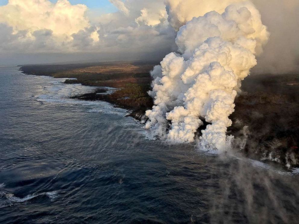 PHOTO: A plume rises where lava pours from the Kilauea Volcano into the sea on the south margin of the fissure 8 flow in Hawaii, July 15, 2018.