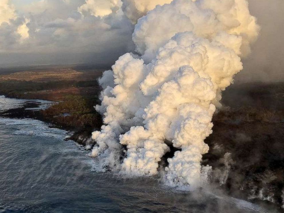 PHOTO: A plume rises where lava pours from the Kilauea Volcano into the sea on the south margin of the fissure 8 flow in Hawaii, July 15, 2018.