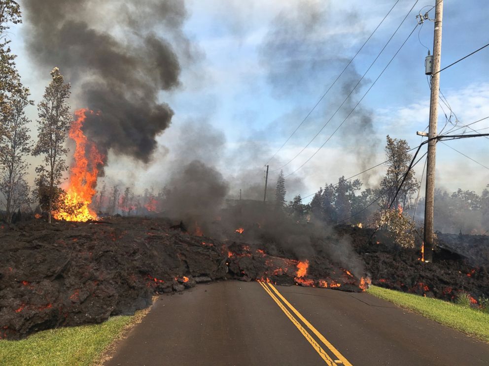 In this Saturday, May 5, 2018, photo provided by the U.S. Geological Survey, lava from Fissure 7 slowly advances to the northeast on Hookapu Street in the Leilani Estates subdivision in Pahoa, Hawaii.