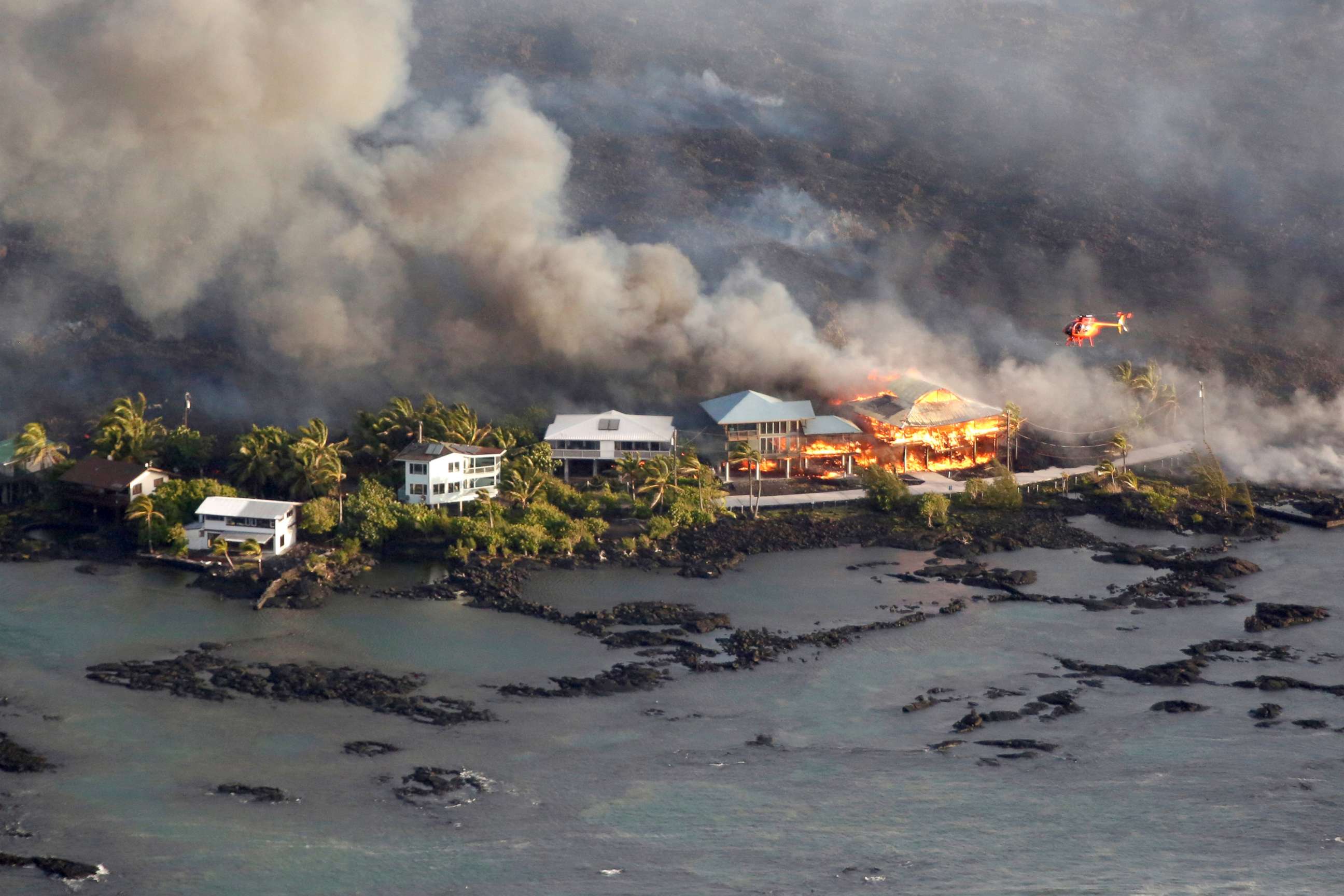 PHOTO: Lava destroys homes in the Kapoho area, east of Pahoa, during ongoing eruptions of the Kilauea Volcano in Hawaii, June 5, 2018.