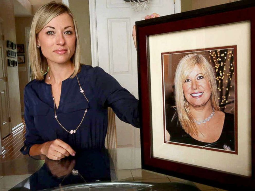 PHOTO: In this May 25, 2016, photo, Kim Pack poses with a photo of her late mother, talk-show host April Kauffman, in Linwood, N.J.