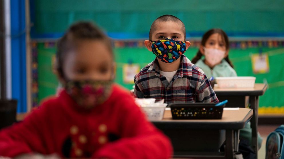 PHOTO: Kindergarten students wearing face masks sit in their classroom on the first day of in-person learning at Maurice Sendak Elementary School in Los Angeles, California, on April 13, 2021, amid the coronavirus pandemic.