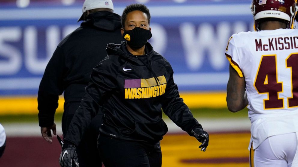 PHOTO: Washington Football Team full-year coaching intern Jennifer King on the field before the start of an NFL wild-card playoff football game against the Tampa Bay Buccaneers, Jan. 9, 2021, in Landover, Md.