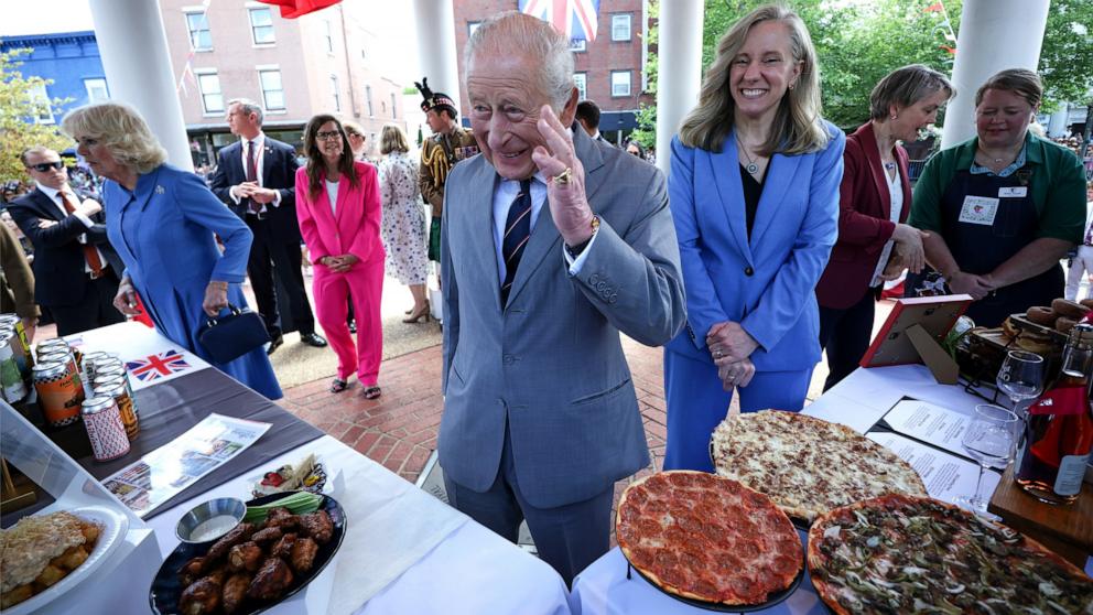 PHOTO: King Charles III and Queen Camilla look at food displayed with Virginia Gov. Abigail Spanberger during a parade and block party event, April 30, 2026 in Front Royal, Virginia.