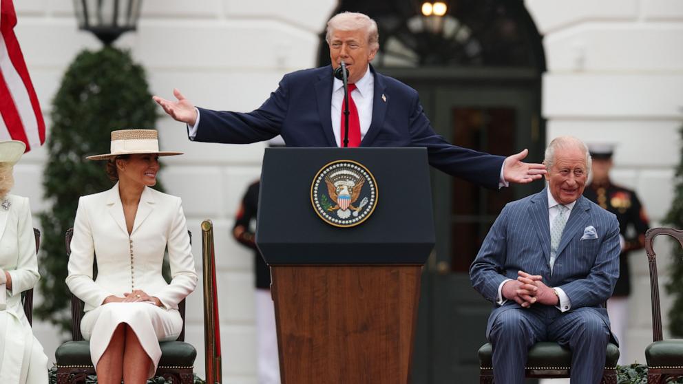 PHOTO: President Donald Trump speaks as First lady Melania Trump and King Charles III listen during a state arrival ceremony on the South Lawn of the White House, April 28, 2026 in Washington