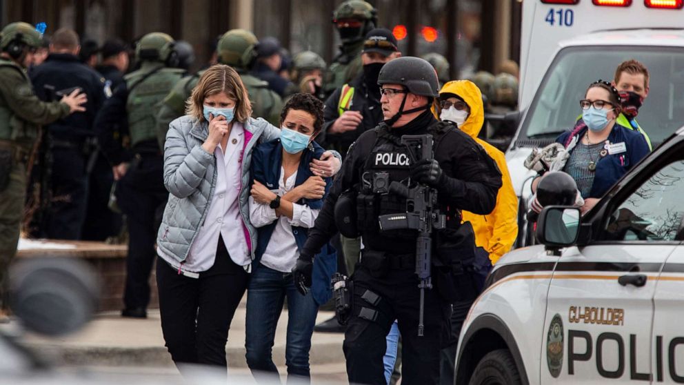 PHOTO: People walk out of a King Sooper's Grocery store after a gunman opened fire on March 22, 2021, in Boulder, Colo.