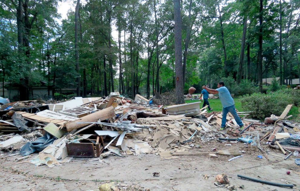 PHOTO: In this Sept. 26, 2017 photo, workers continue clearing debris from the home of Houston resident Chris Slaughter, whose house in the suburb of Kingwood Texas was flooded by 5 1/2 feet of water during Harvey's torrential rainfall.