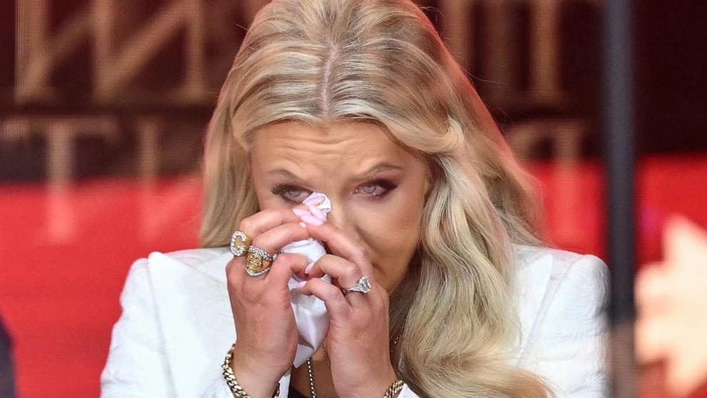 PHOTO: Erika Kirk, Charlie Kirk's widow, wipes away tears as she speaks during the public memorial service for right-wing activist Charlie Kirk in Glendale, Arizona, September 21, 2025. 