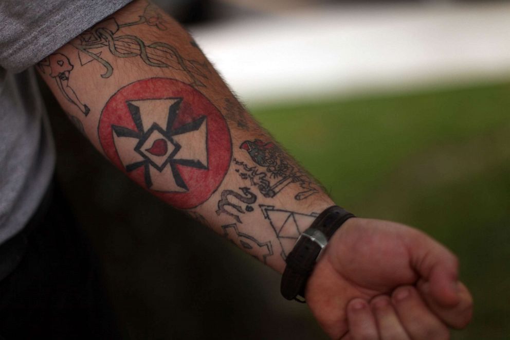 PHOTO: A man displays a Ku Klux Klan cross tattooed onto his arm during a march on July 11, 2009, in Pulaski, Tenn.