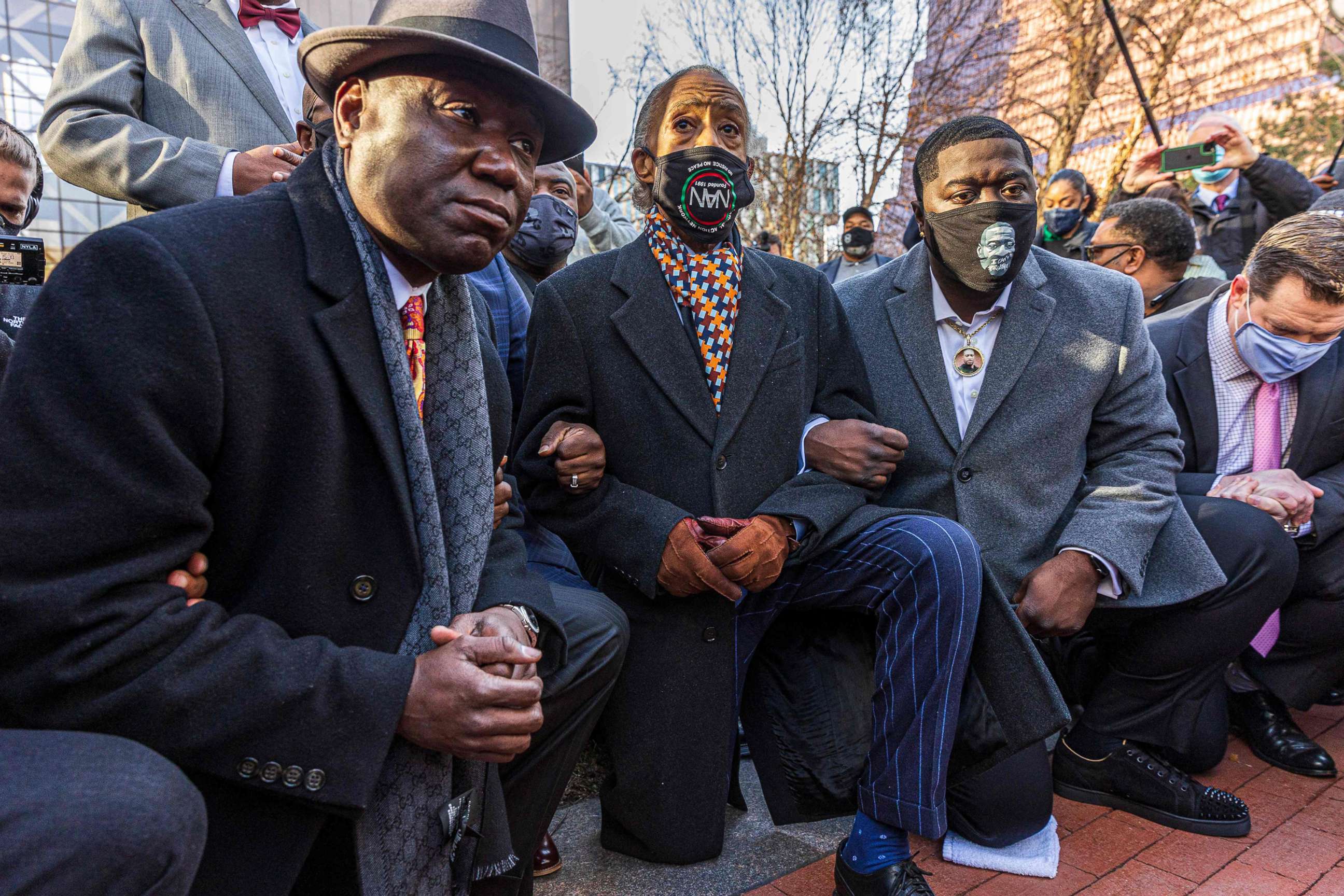 PHOTO: Floyd family lawyer, Attorney Ben Crump, left,and Rev. Al Sharpton, the founder and President of National Action Network,center, and George Floyd's brother kneel on March 29, 2021 in Minneapolis.