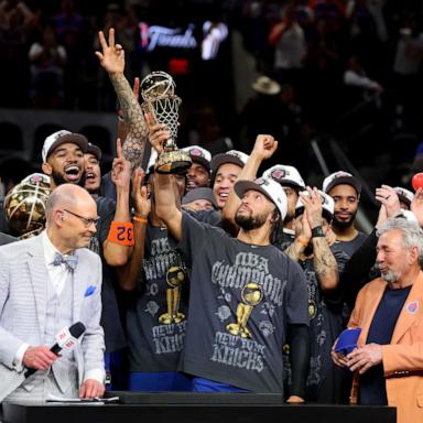 PHOTO: Jalen Brunson of the New York Knicks lifts the Bill Russell NBA Finals Most Valuable Player Award trophy after defeating the San Antonio Spurs in Game Five of the 2026 NBA Finals, June 13, 2026 in San Antonio.