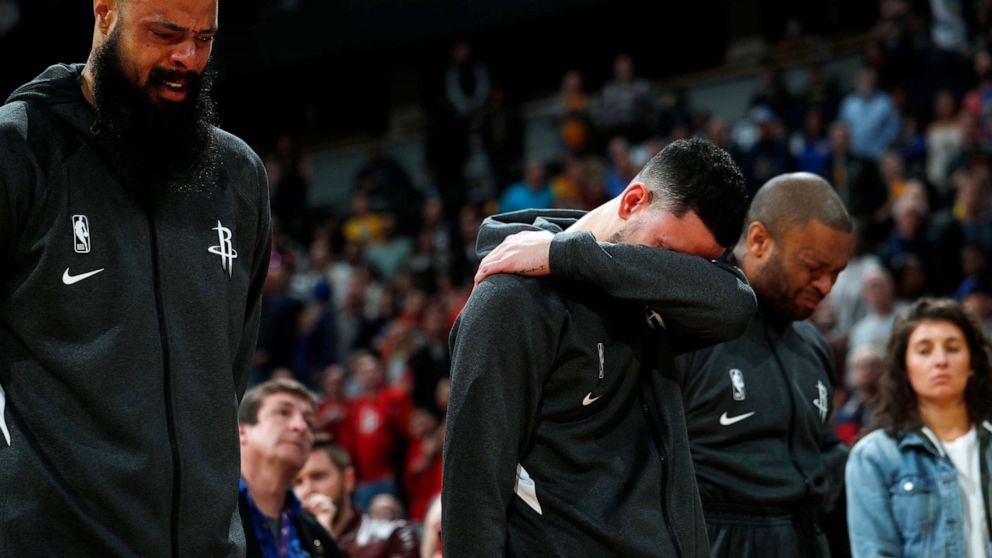 PHOTO: From left to right, Houston Rockets center Tyson Chandler, guard Austin Rivers and forward P.J. Tucker react during a tribute to Kobe Bryant before an NBA basketball game against the Denver Nuggets, Jan. 26, 2020, in Denver. 