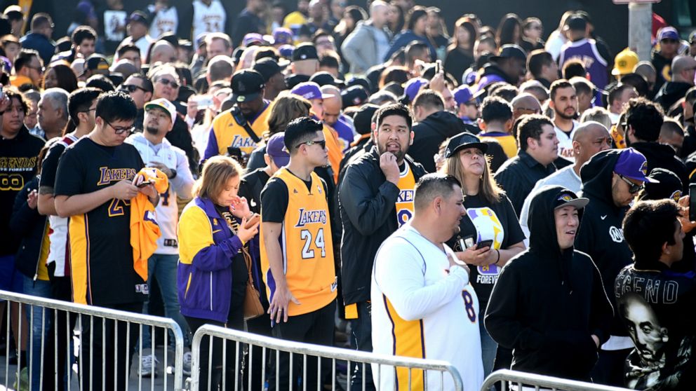 PHOTO: Fans line up outside to Staples Center waiting to enter to attend the memorial to celebrate the life of Kobe Bryant and daughter Gianna Bryant, Los Angeles, Feb. 24, 2020.
