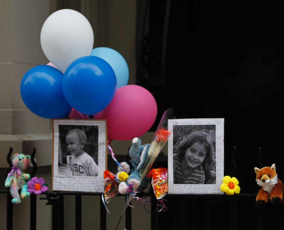 PHOTO: Photographs of the two children allegedly stabbed by their nanny are displayed alongside balloons and stuffed animals at a memorial outside the apartment building were they lived in New York City, Oct. 27, 2012.