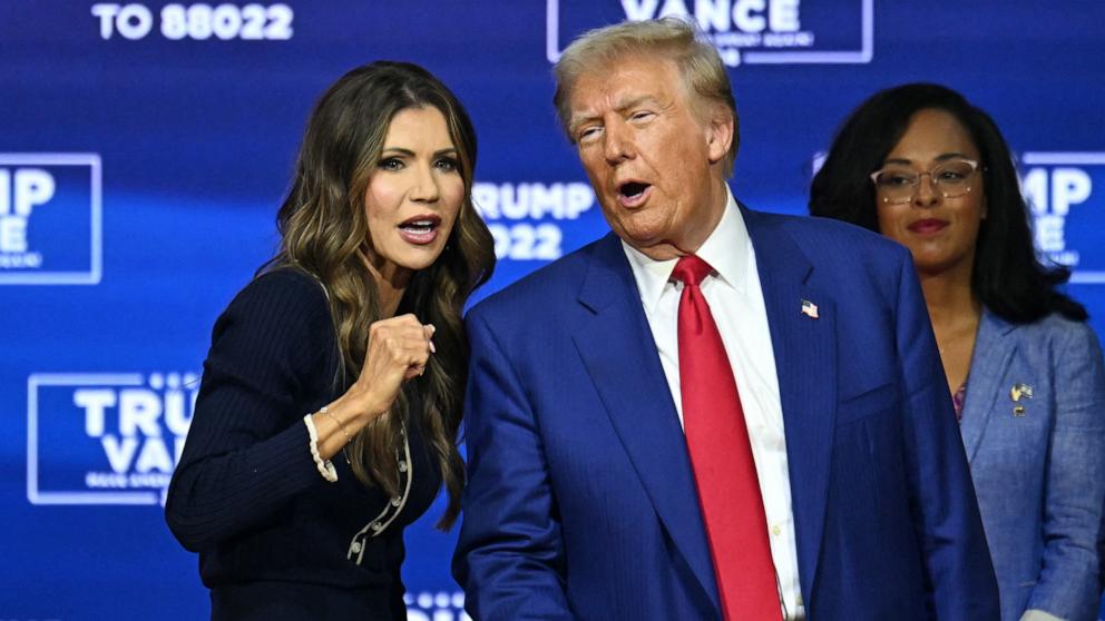 PHOTO: Former President and Republican presidential candidate Donald Trump speaks with moderator and South Dakota Governor Kristi Noem during a town hall in Oaks, Pennsylvania, Oct. 14, 2024.