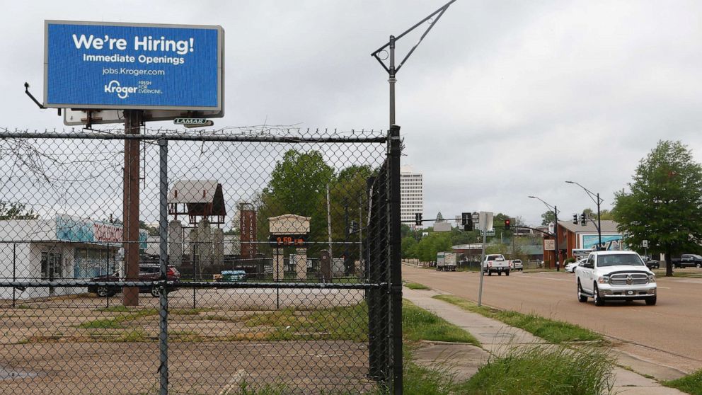 PHOTO: A sign announces that Kroger Company is hiring, March 23, 2020, in Jackson, Miss.