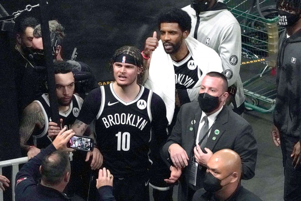 PHOTO: Brooklyn Nets guard Kyrie Irving gives a thumbs up as he and Nets guard Tyler Johnson (10) engage with fans after they defeated the Boston Celtics in Game 4 during an NBA basketball first-round playoff series, May 30, 2021, in Boston.
