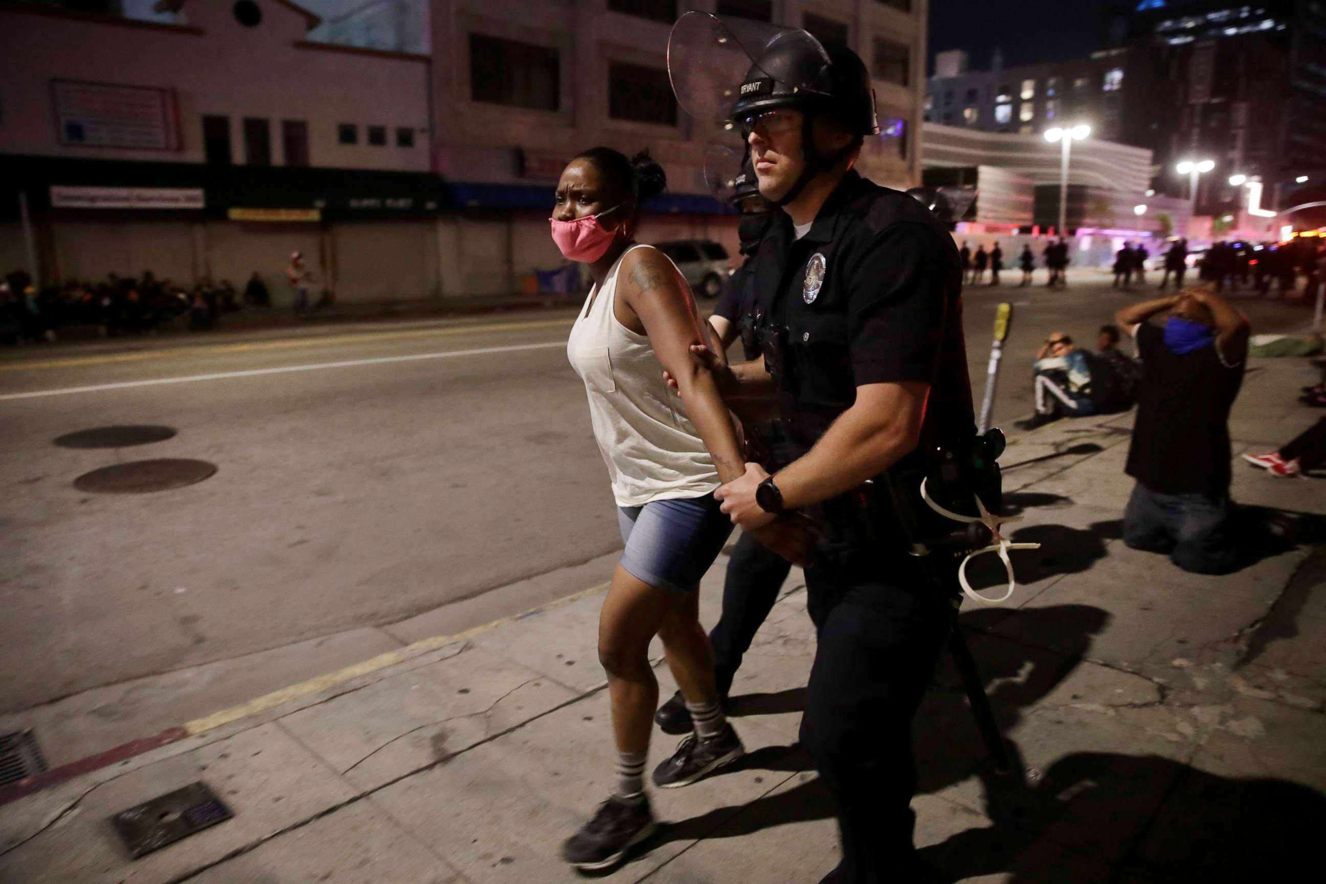 PHOTO: FILE - In this May 31, 2020, file photo, a police officer arrests a woman as protests over the death of George Floyd continued in Los Angeles. 