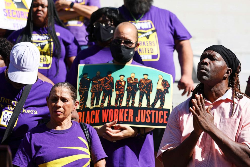 PHOTO: Pastor Stephen Cue Jn-Marie stands with SEIU California union members at a demonstration outside City Hall calling for the resignations of L.A. City Council members in the wake of a leaked audio recording on October 18, 2022 in Los Angeles.