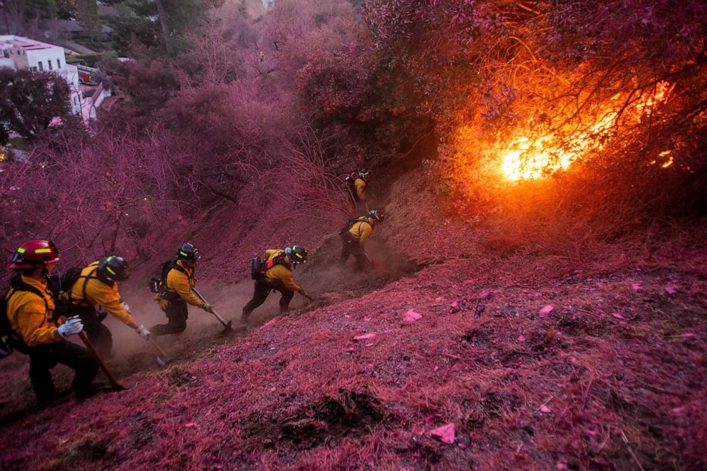 PHOTO: Firefighters work to clear a firebreak as the Palisades Fire, one of several simultaneous blazes that have ripped across Los Angeles County, burns in Mandeville Canyon, a neighborhood of Los Angeles, California, Jan. 12, 2025.