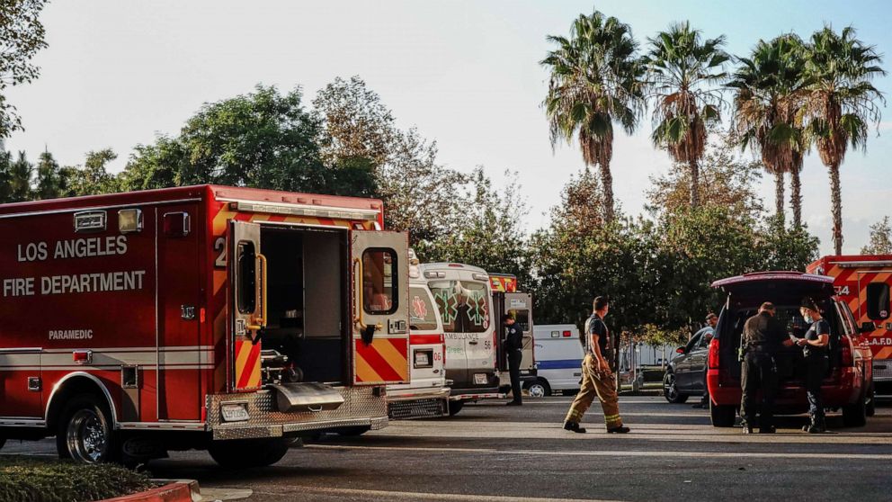 PHOTO: Firefighters and paramedics wait outside LAC + USC Medical Center during a surge of coronavirus disease (COVID-19) cases in Los Angeles, California, U.S., December 27, 2020.  