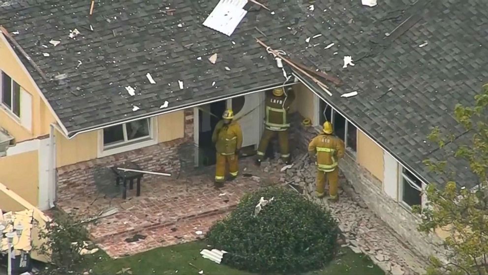 PHOTO: Los Angeles firefighters inspect the home and put up caution tape in dangerous areas of a home that exploded on Sept. 20, 2017, in western Los Angeles.