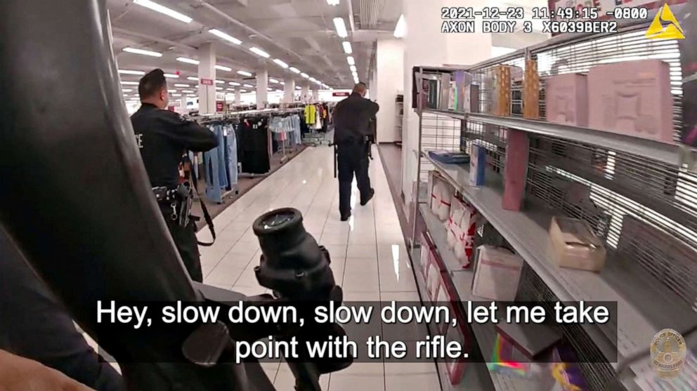 PHOTO: Los Angeles Police Department officers walk around a shopping mall in North Hollywood, Calif, Dec. 23, 2021.A 14-year-old girl was killed when a bullet pierced the wall of her dressing room as officers opened fire on an assault suspect.