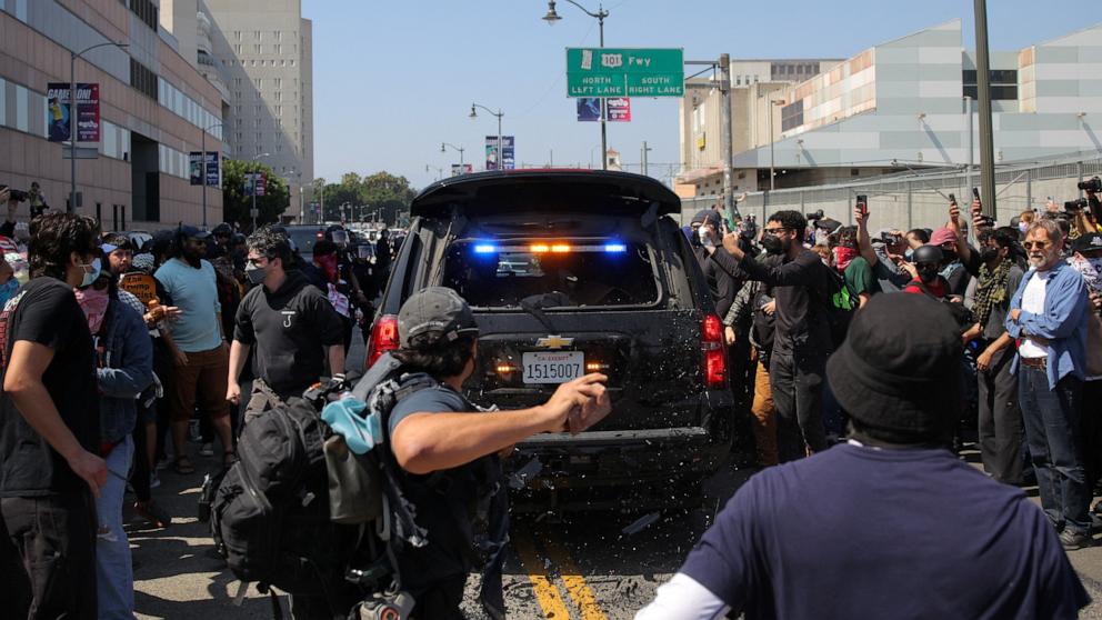 PHOTO: A demonstrator throws a rock towards a law enforcement vehicle during a protest against federal immigration sweeps in downtown Los Angeles, June 8, 2025.