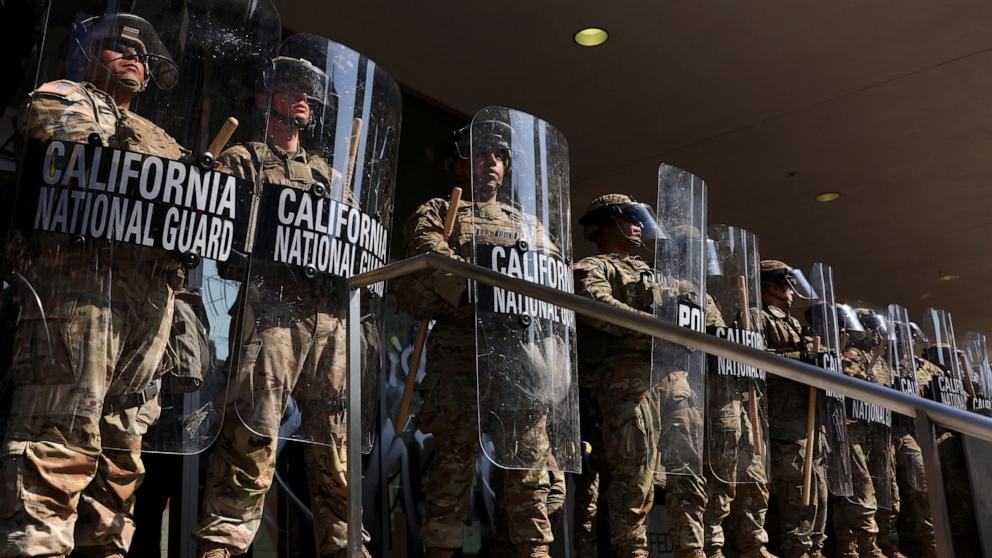 PHOTO: California National Guard troops stand guard as people attend a rally against federal immigration sweeps, in Los Angeles, June 9, 2025.