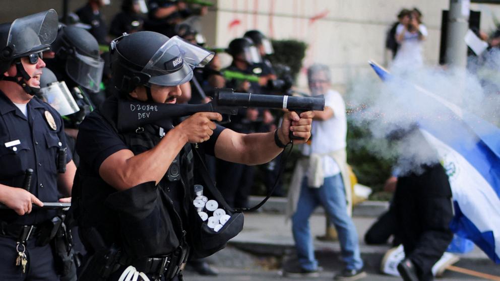A member of law enforcement fires crowd control munitions as protests against federal immigration sweeps continue, in Los Angeles, California, June 9, 2025. Protests against immigration sweeps continue, in Los Angeles