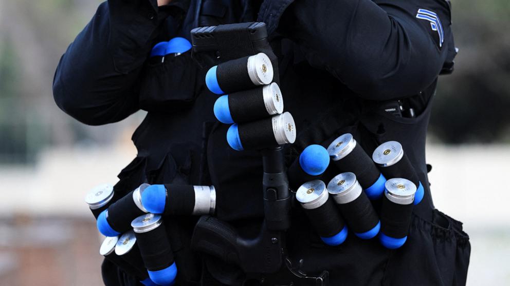 PHOTO: A law enforcement officer carries rubber bullets, during a protest against federal immigration sweeps in downtown Los Angeles, June 9, 2025.