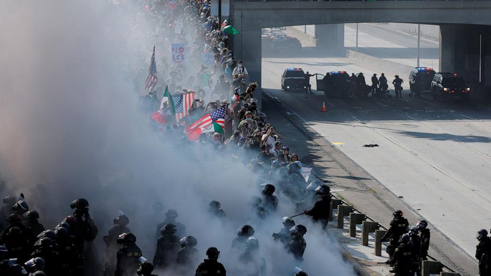 PHOTO: Police face off with demonstrators amid smoke during a protest against federal immigration sweeps in downtown Los Angeles, June 8, 2025.