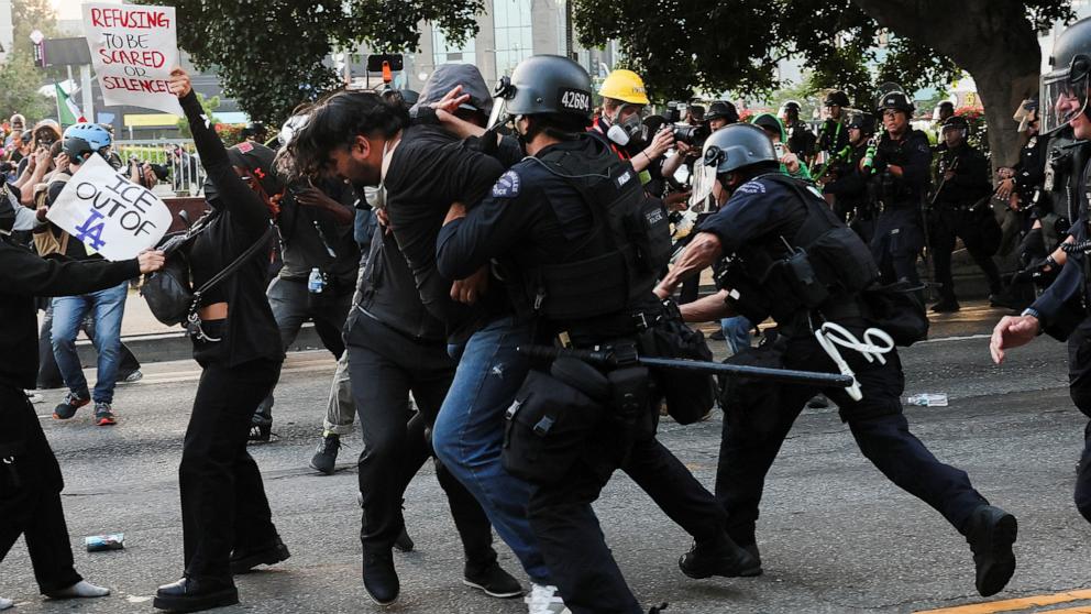 PHOTO: Police officers detain a demonstrator, during protests against federal immigration sweeps, in Los Angeles, June 9, 2025.