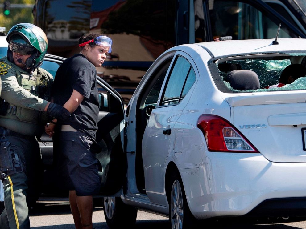 PHOTO: An unidentified woman is taken into custody after witnesses said she drove her car into a crowd of protesters in Yorba Linda, Calif., Saturday, Sept. 26, 2020. 