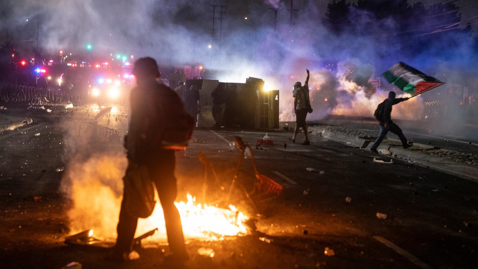 A protester waves the Palestinian flag as law enforcement clashes with demonstrators during a protest following federal immigration operations, in the Compton neighborhood of Los Angeles, Calif., June 7, 2025. 
