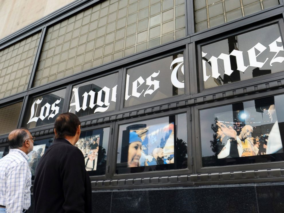 PHOTO: In this May 16, 2016, file photo, pedestrians look at news photos posted outside the Los Angeles Times building in downtown Los Angeles.