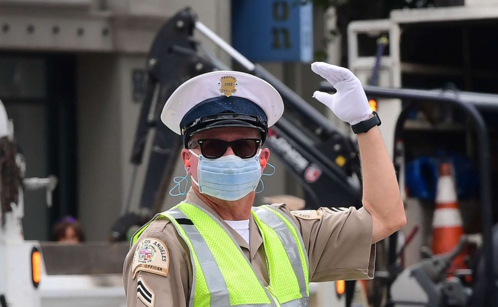 PHOTO: A traffic officer wears a mask as he directs traffic in Los Angeles, California, on March 24, 2020.