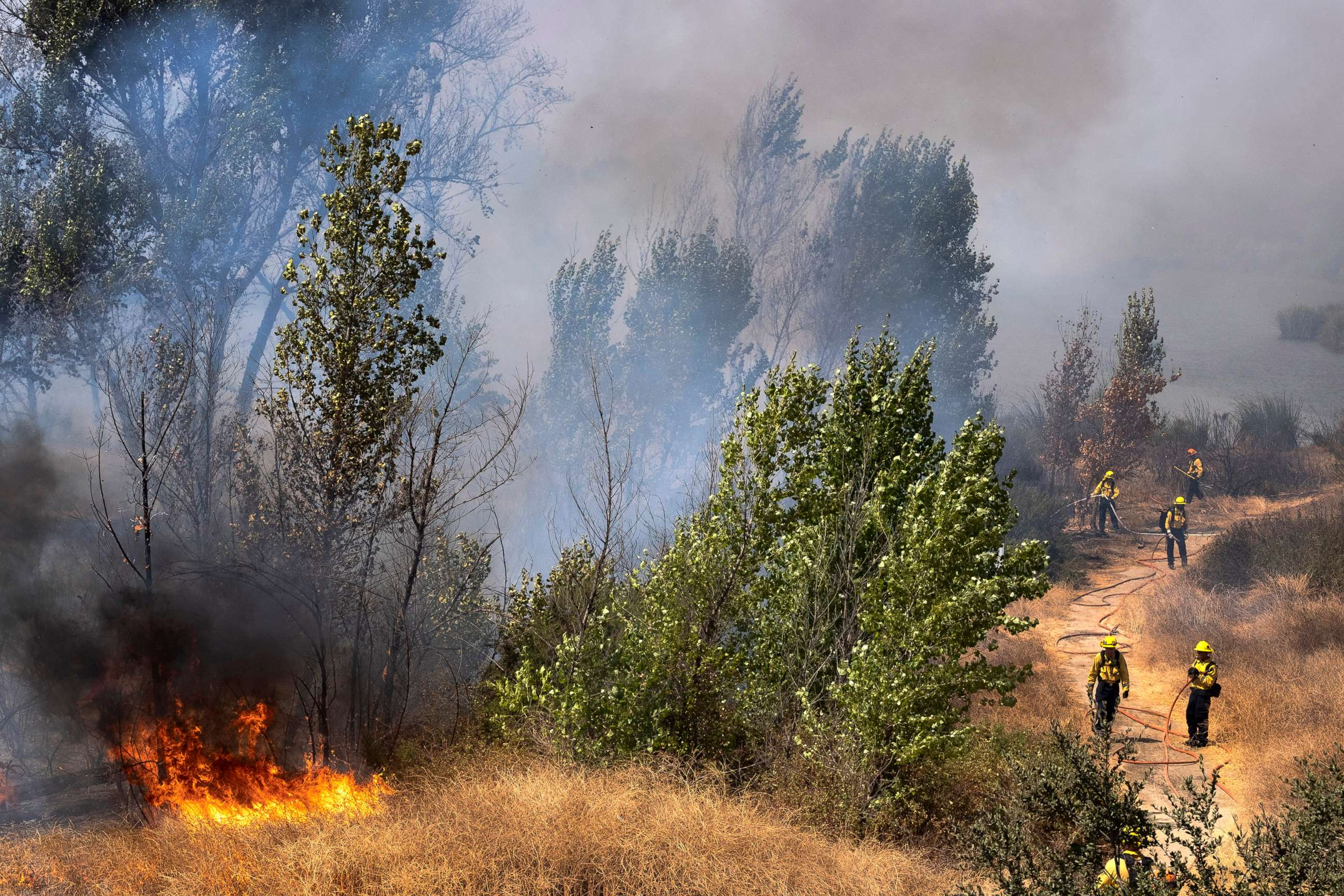 PHOTO: Los Angeles Fire Department firefighters work to douse brush fires in the Sepulveda Basin in the Sherman Oaks area of Los Angeles, Sunday, Sept. 6, 2020. 