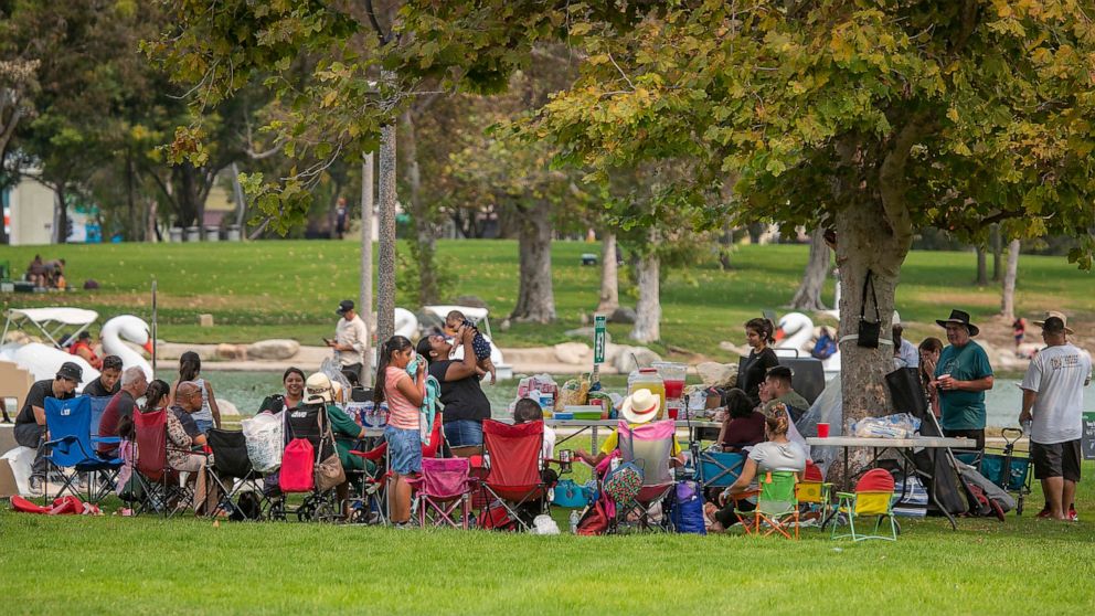 PHOTO: A large family has a picnic together as they join hundreds of people spreading out over Mile Square Park to celebrate Labor Day with their families, Sept. 7, 2020, in Fountain Valley, Calif.