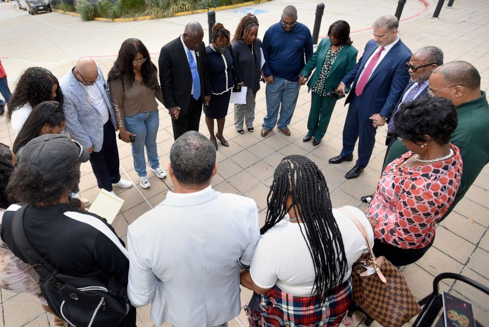 PHOTO: Descendants of Henrietta Lacks, whose cells, known as HeLa cells, have been used in medical research without her permission, say a prayer with attorneys outside the federal courthouse in Baltimore, Oct. 4, 2021.