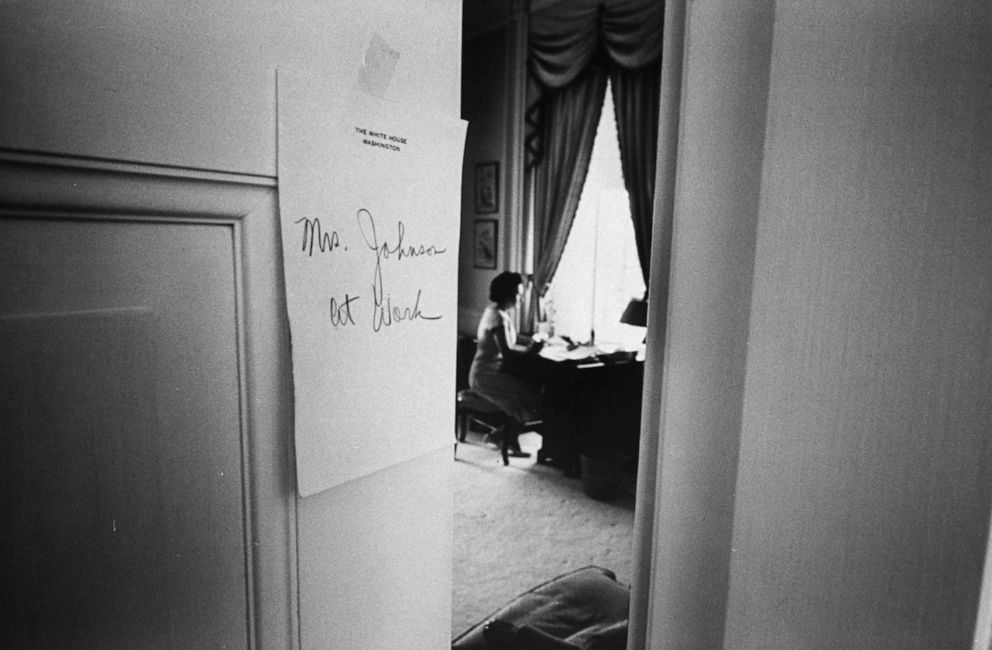 PHOTO: First lady Lady Bird Johnson is at work seated at her desk in the White House in Washington, D.C., 1964.