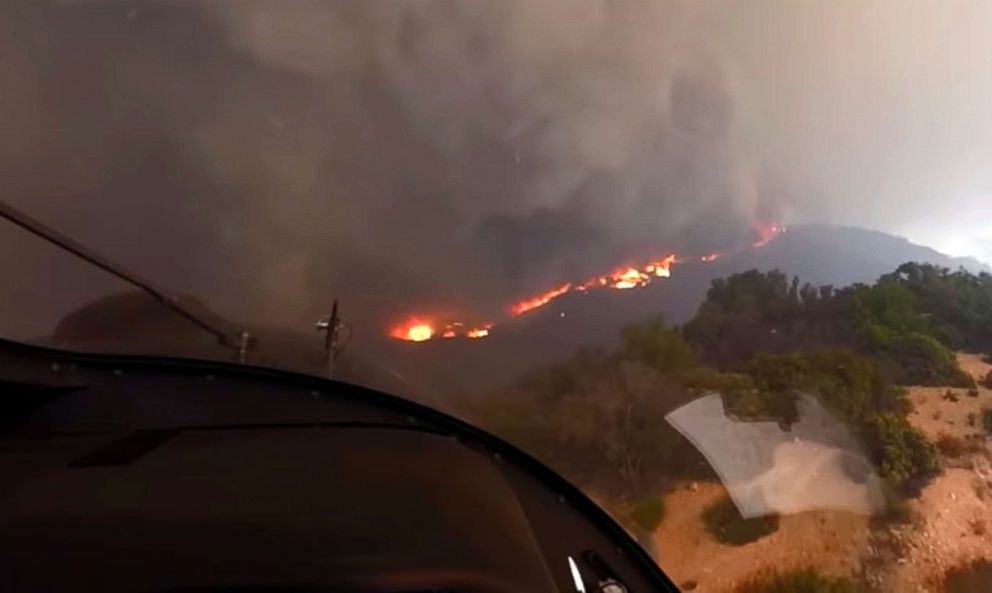 PHOTO: In this Nov. 9, 2018 photo from video provided by the Los Angeles Fire Department, LAFD pilot David Nordquist records flames approaching after rescuing three people and two dogs from Castro Peak in the Santa Monica Mountains in Malibu, Calif.