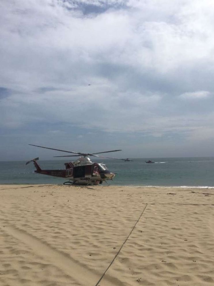 PHOTO: Rescue at EBay under way for juvie that has arm trapped under a rock, Laguna Beach California, July 18, 2018.