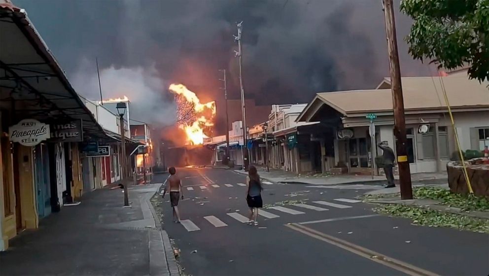 PHOTO: People watch as smoke and flames fill the air from raging wildfires on Front Street in downtown Lahaina, Maui, on Tuesday, Aug. 9, 2023.