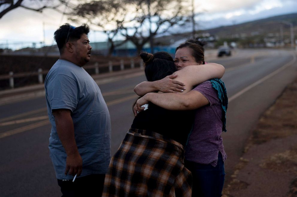 PHOTO: Nora Bulosan, right, and Hannah Tomas, Lahaina, Hawaii residents who survived the fire that devastated the town, comfort each other as they gather in hopes to get access to their home in Lahaina, Hawaii, Aug. 16, 2023.